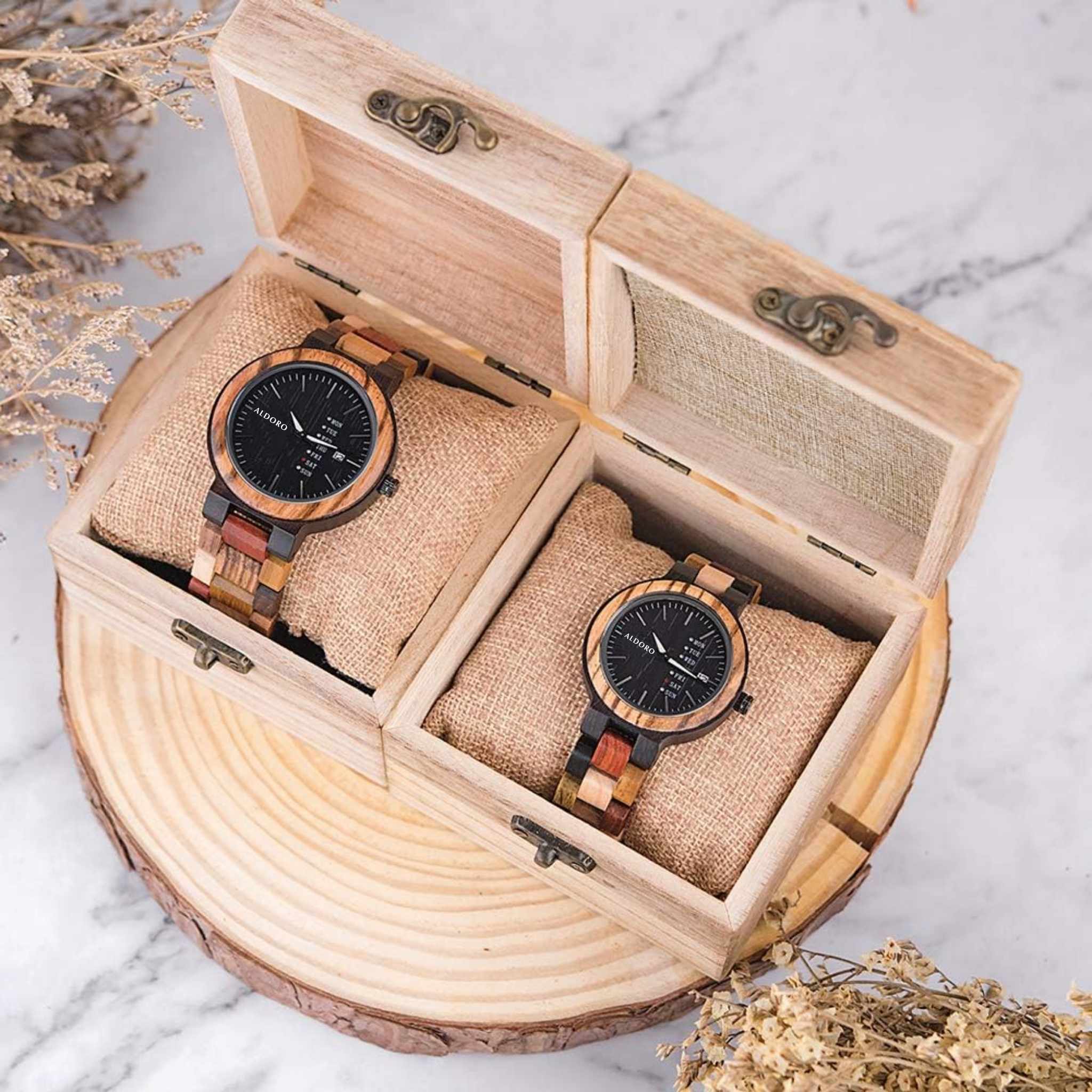 Two Aldoro luxury wooden watches displayed in a natural wood gift box, showcasing craftsmanship and sustainable elegance.