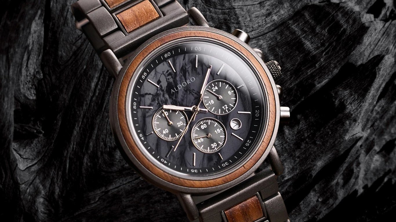Aldoro men’s luxury wooden chronograph watch with dark wood grain and metal accents, displayed on natural bark background, symbolizing craftsmanship and sustainable elegance.